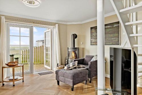 a living room with a couch and a fireplace at 0332-Romo-Sonder-Frankel-38 in Havneby