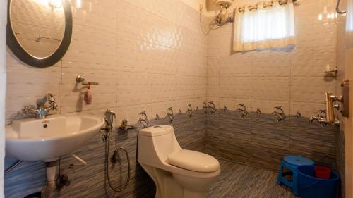 a bathroom with a toilet and a sink at Seven Springs Plantation Resort in Munnar
