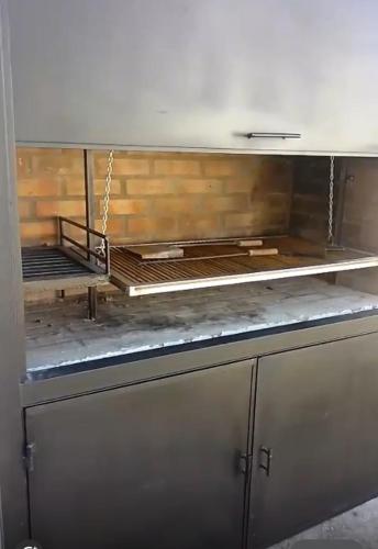 a kitchen with a metal counter top in a room at Casa a Estrenar - Monte Hermoso in Monte Hermoso