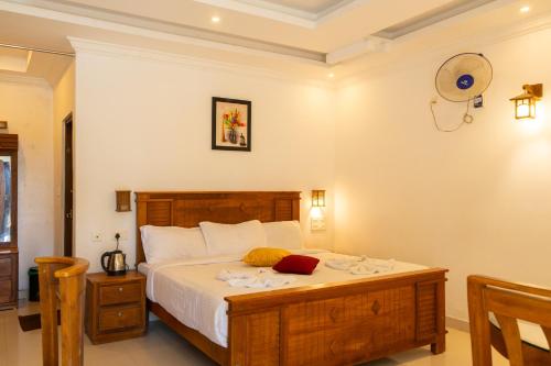 a bedroom with a large bed in a room at Seven Springs Plantation Resort in Munnar