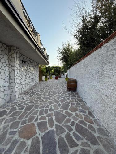 a stone walkway next to a stone wall at Greenlove in Agerola