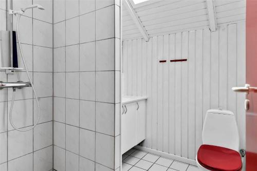a white bathroom with a shower and a toilet at 0300-Romo-Vestergade-3-Ap-73 in Havneby