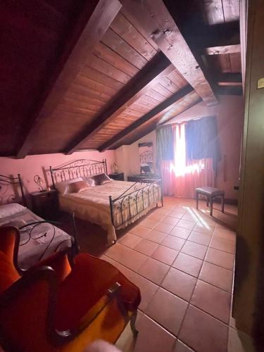 a bedroom with a large bed and a window at I Santicelli in Morano Calabro