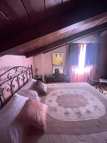a bedroom with a large bed and a mirror at I Santicelli in Morano Calabro