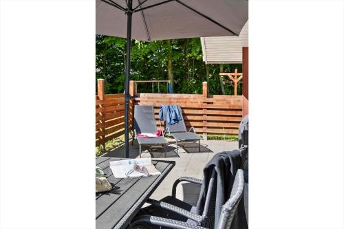 a patio with a table and chairs and an umbrella at 0651-Toftlund-Skikkild-bjerge-20 in Toftlund