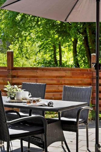 a table and chairs with an umbrella on a patio at 0651-Toftlund-Skikkild-bjerge-20 in Toftlund