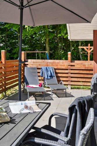 a patio with a table and chairs and an umbrella at 0651-Toftlund-Skikkild-bjerge-20 in Toftlund
