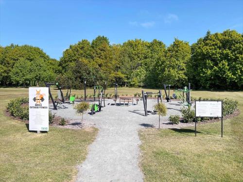 a park with a playground with signs in the grass at 0651-Toftlund-Skikkild-bjerge-20 in Toftlund