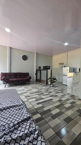 a living room with a couch and a checkered floor at Rincón del Sol in Upala