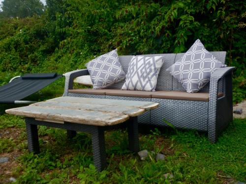 a couch and a coffee table with pillows on it at Adrigole Bay Studio Apartment in Adrigole