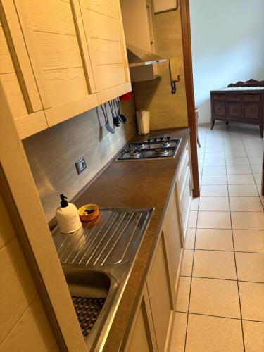 a kitchen with a sink and a stove at Civico 16 in Asso