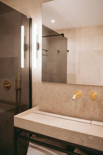 a bathroom with a sink and a mirror at Rondaia, a Winery & Fincahotel-Agroturismo in Tramuntana in Esporles