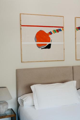 a bedroom with a bed with a picture above it at Rondaia, a Winery & Fincahotel-Agroturismo in Tramuntana in Esporles