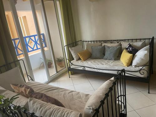 a couch with pillows on it in a living room at Appartement OCEAN VIEW in Tamraght Ouzdar