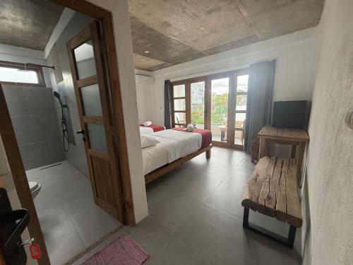 a bedroom with a bed and a sliding glass door at Nextdoor Rooms in Yogyakarta
