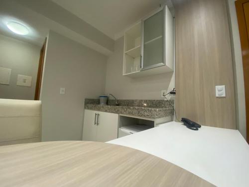 a white room with a bed and a counter at IMG Hotel Rio Quente in Rio Quente