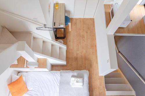 a small bedroom with white walls and wood floors at FukuokaKukouGoodStay in Fukuoka