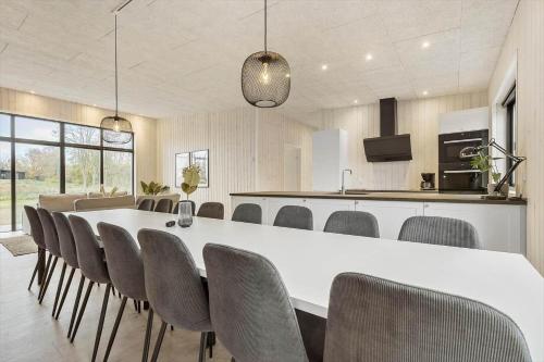 a large dining room with a white table and chairs at 8902-Allingabro-Dalgardsvej-4 in Allingåbro