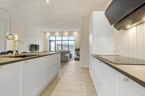 a kitchen with white cabinets and a counter top at 8902-Allingabro-Dalgardsvej-4 in Allingåbro
