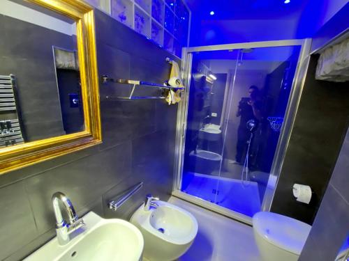 a bathroom with a sink and a shower with a mirror at The Manarola Main Plaza in Manarola