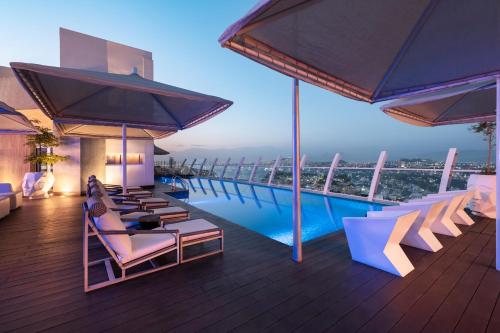 a resort with a pool and lounge chairs on a deck at Hard Rock Hotel Guadalajara in Guadalajara