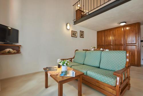 a living room with a couch and a table at Casanova - Wellness Center La Grotta Etrusca in San Quirico dʼOrcia