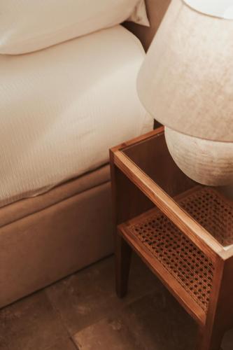 a bed with a nightstand next to a bed with a pillow at Rondaia, a Winery & Fincahotel-Agroturismo in Tramuntana in Esporles