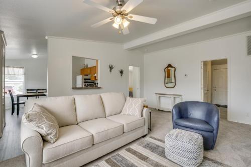 a living room with a white couch and a blue chair at 1 Mi to Main Street Cozy Retreat in Portales in Portales