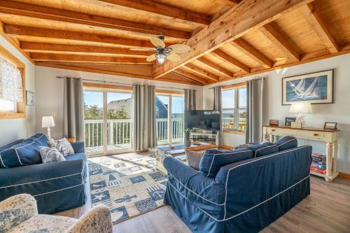a living room with blue couches and a wooden ceiling at Duck Life D4242 - Pool, Rec Room, Sound View in Sanderling