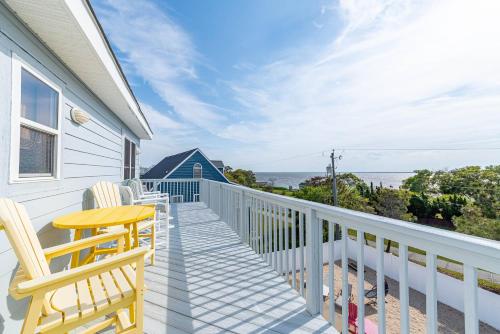 a balcony with chairs and a table and the ocean at Duck Life D4242 - Pool, Rec Room, Sound View in Sanderling