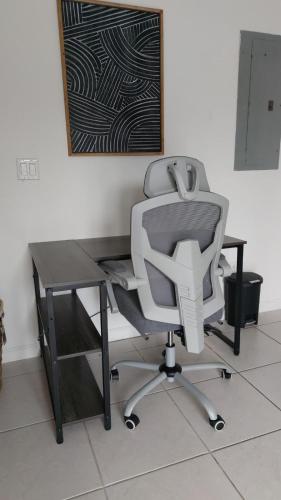 a desk with a chair and a computer monitor at Super Room 5 minutes from PBI Airport in West Palm Beach