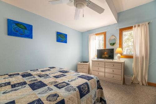 a bedroom with a bed and a flat screen tv at Duck Life D4242 - Pool, Rec Room, Sound View in Sanderling