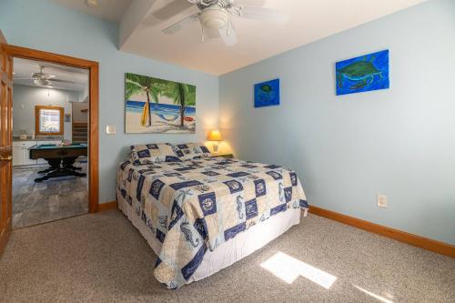 a bedroom with a bed and a bathroom at Duck Life D4242 - Pool, Rec Room, Sound View in Sanderling