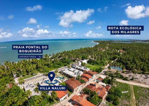 an aerial view of a resort near the ocean at Villa Naluri - Seu Refúgio a 50 metros da praia em Japaratinga in Japaratinga