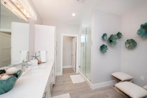 a bathroom with a large mirror and a sink at Mahogany Villa 2-A / 4BR in Omega Gardens