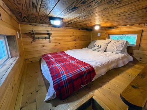 a bedroom in a log cabin with a bed in it at Shiners Shack in Newport