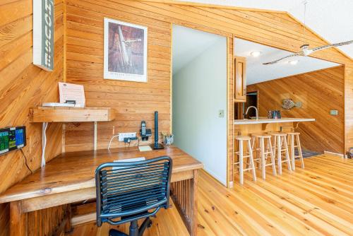 a home office with a desk in a wooden wall at Duck Redux - D0416 in Duck