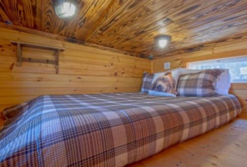 a bedroom with a bed in a log cabin at Shiners Shack in Newport