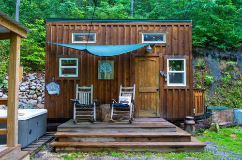 a tiny house with two chairs and a porch at Shiners Shack in Newport