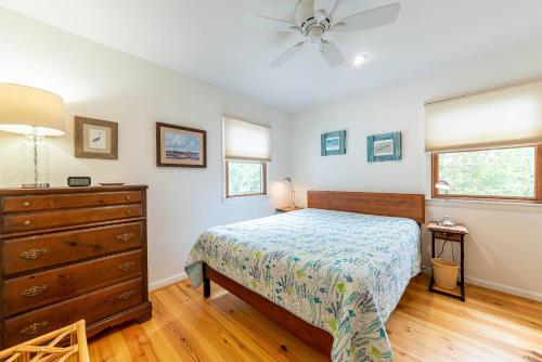 a bedroom with a bed and a dresser at Duck Redux - D0416 in Duck