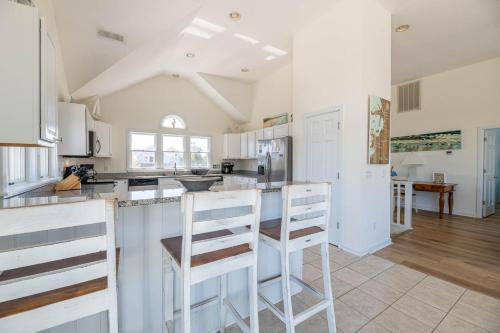 a kitchen with white cabinets and a counter top at D0597 Dune Fine - Duck Landing Amenities, Pool, Hot Tub, Pets OK, Keyless! in Duck