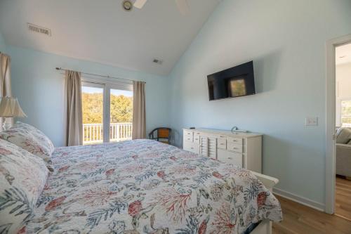 a bedroom with a bed and a window at D0597 Dune Fine - Duck Landing Amenities, Pool, Hot Tub, Pets OK, Keyless! in Duck