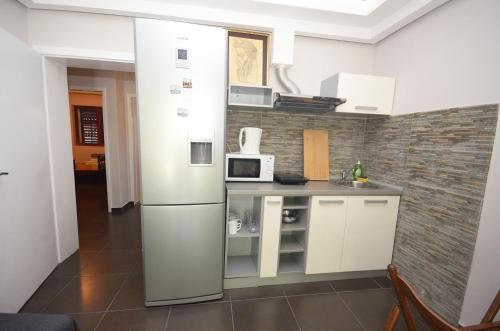 a kitchen with a refrigerator in a room at Apartments Dakovic in Kotor