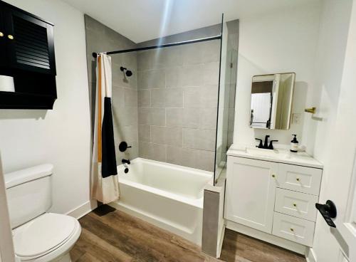 a bathroom with a shower and a toilet and a sink at Modern LA Guest House in Los Angeles