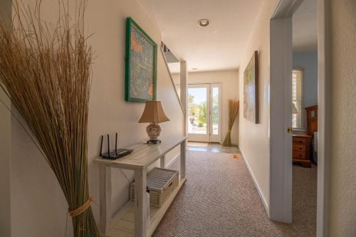 a hallway with a table with a lamp on it at D0597 Dune Fine - Duck Landing Amenities, Pool, Hot Tub, Pets OK, Keyless! in Duck