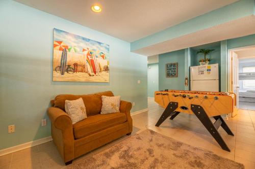 a living room with a couch and a pool table at D0597 Dune Fine - Duck Landing Amenities, Pool, Hot Tub, Pets OK, Keyless! in Duck
