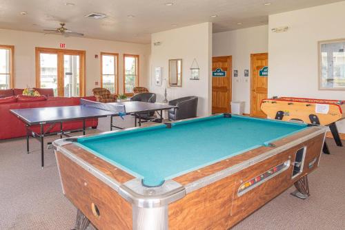 a pool table in a room with ping pong tables at D0597 Dune Fine - Duck Landing Amenities, Pool, Hot Tub, Pets OK, Keyless! in Duck