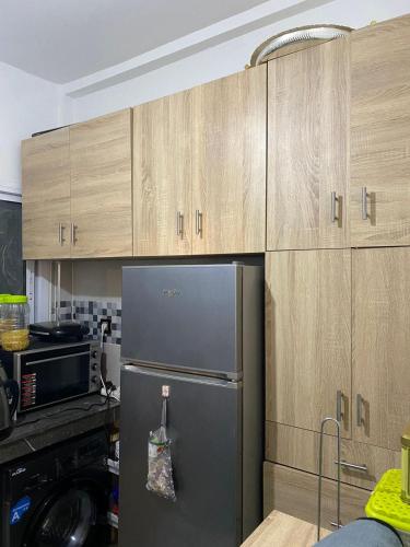 a kitchen with a refrigerator and wooden cabinets at Joude in Fez