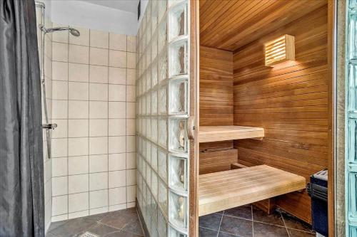 a sauna with wooden walls and wooden shelves in a bathroom at 0286-Romo-Sonder-Frankel-34 in Havneby