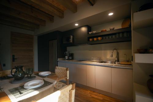 a kitchen with a table and a sink and a counter at Kineki 8 in Brisas de Zicatela